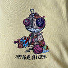 Beige t-shirt with a cartoon character and text on a beige background