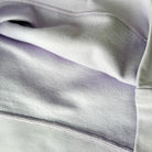 Close-up of gray fabric with a focus on texture and pattern.