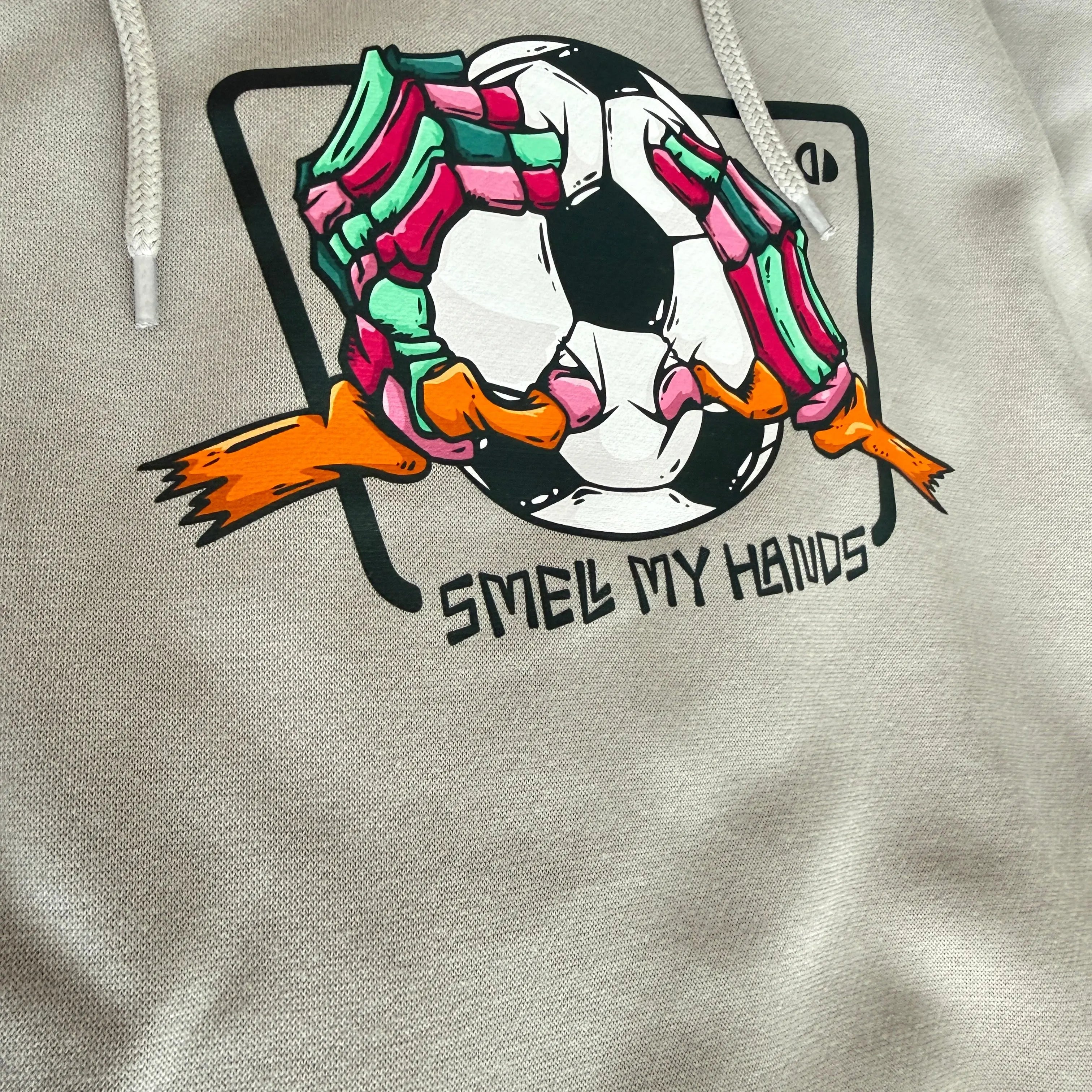 Tote bag with a colorful graphic of a soccer ball and text on a beige background